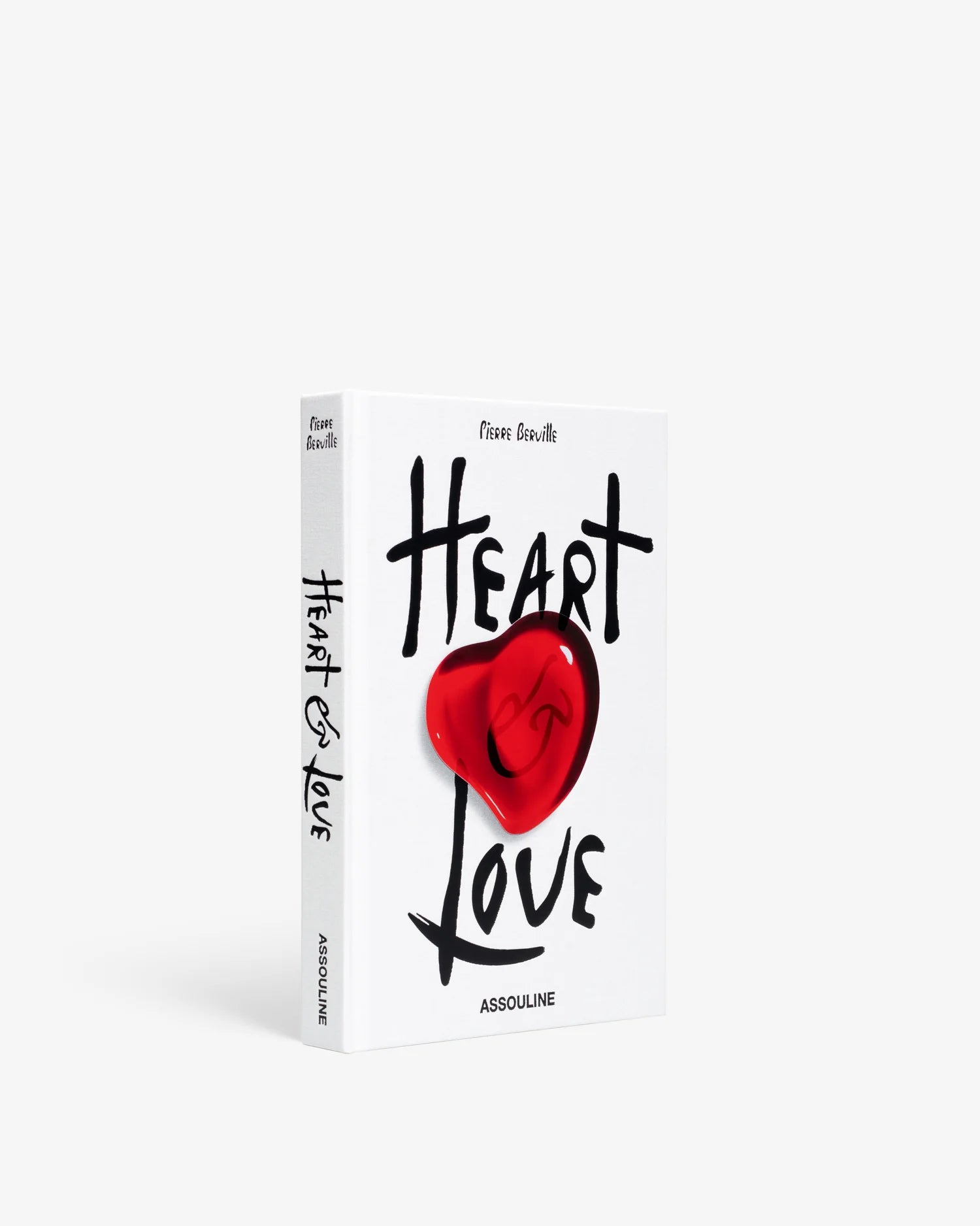 Libro decorativo de lujo Assouline Heart & Love, vista lateral con portada blanca y corazón rojo.
