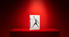 Libro Assouline Air Jordan Classic exhibido elegantemente en un pedestal rojo con iluminación destacada.