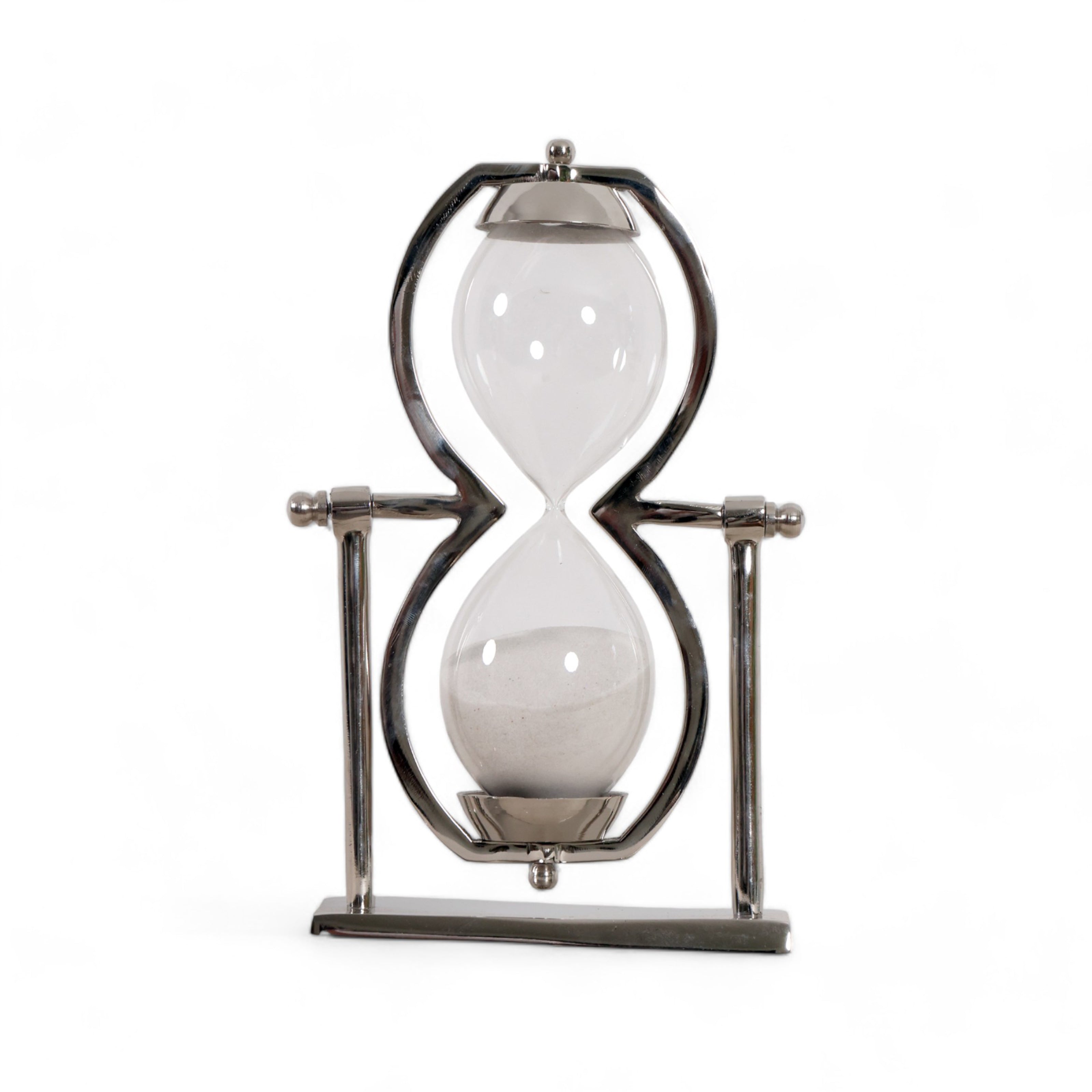 Reloj de arena decorativo de lujo en metal cromado y arena blanca, sobre fondo blanco.