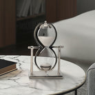 Reloj de arena de lujo en ambiente de sala moderna, sobre mesa de mármol, pieza central decorativa.