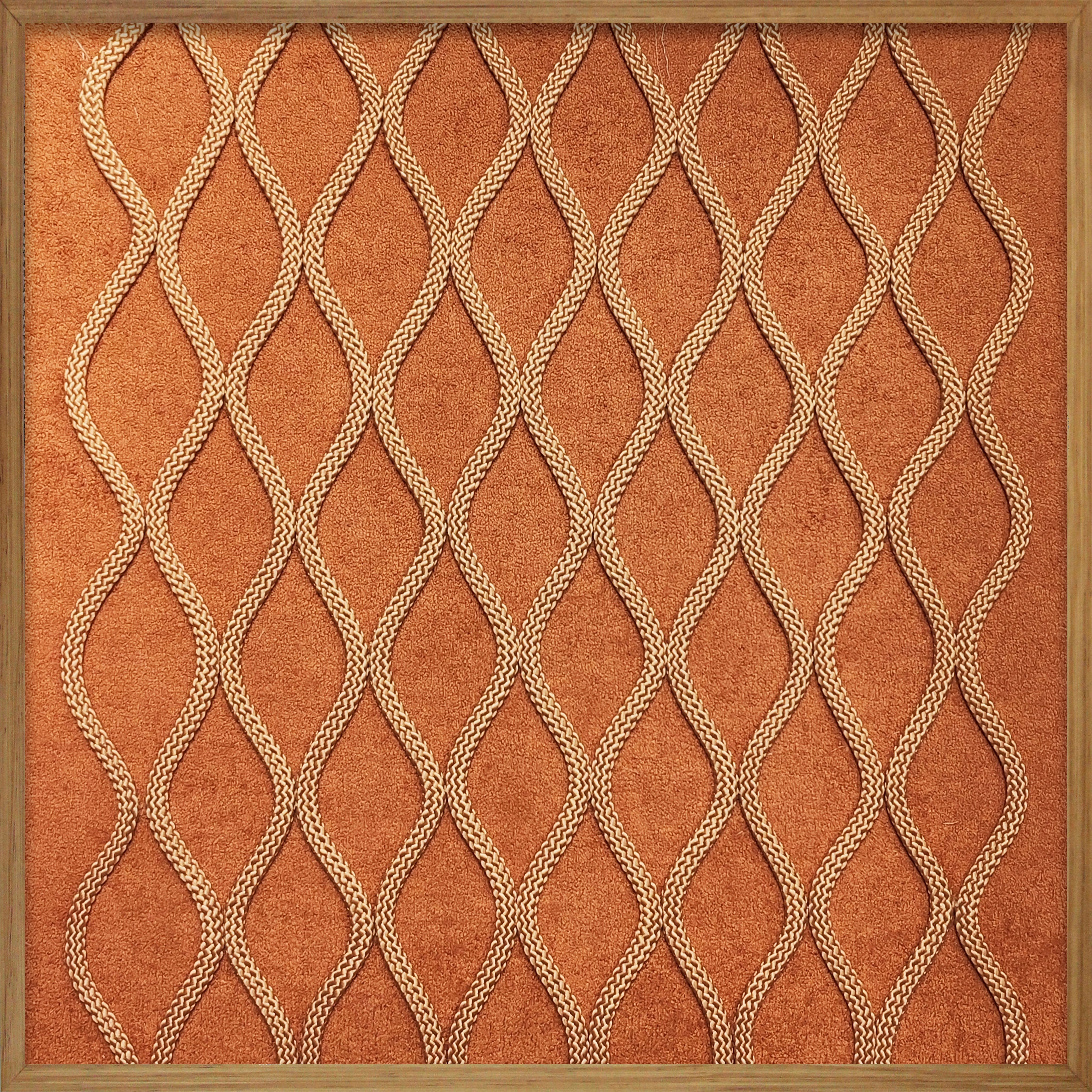 Cuadro Vilá Decoración con marco de madera, fondo de tela color terracota y diseño de cuerda.