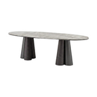 Mesa de comedor ovalada moderna con cubierta de piedra tipo mármol y bases cónicas de madera oscura.