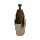 Botellón decorativo geométrico bronce con diseño facetado y tope de piedra verde pulida.